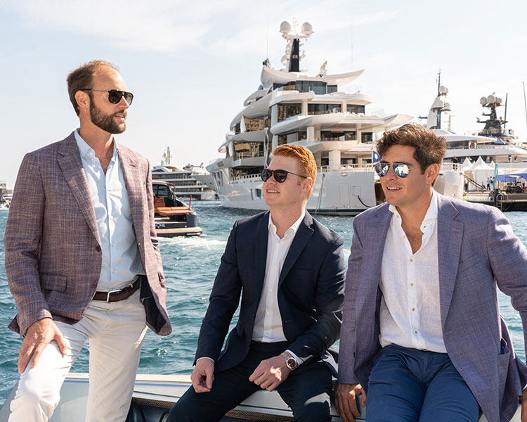 Kitson Yacht superyacht sales founders partners in suits sitting on a yacht.