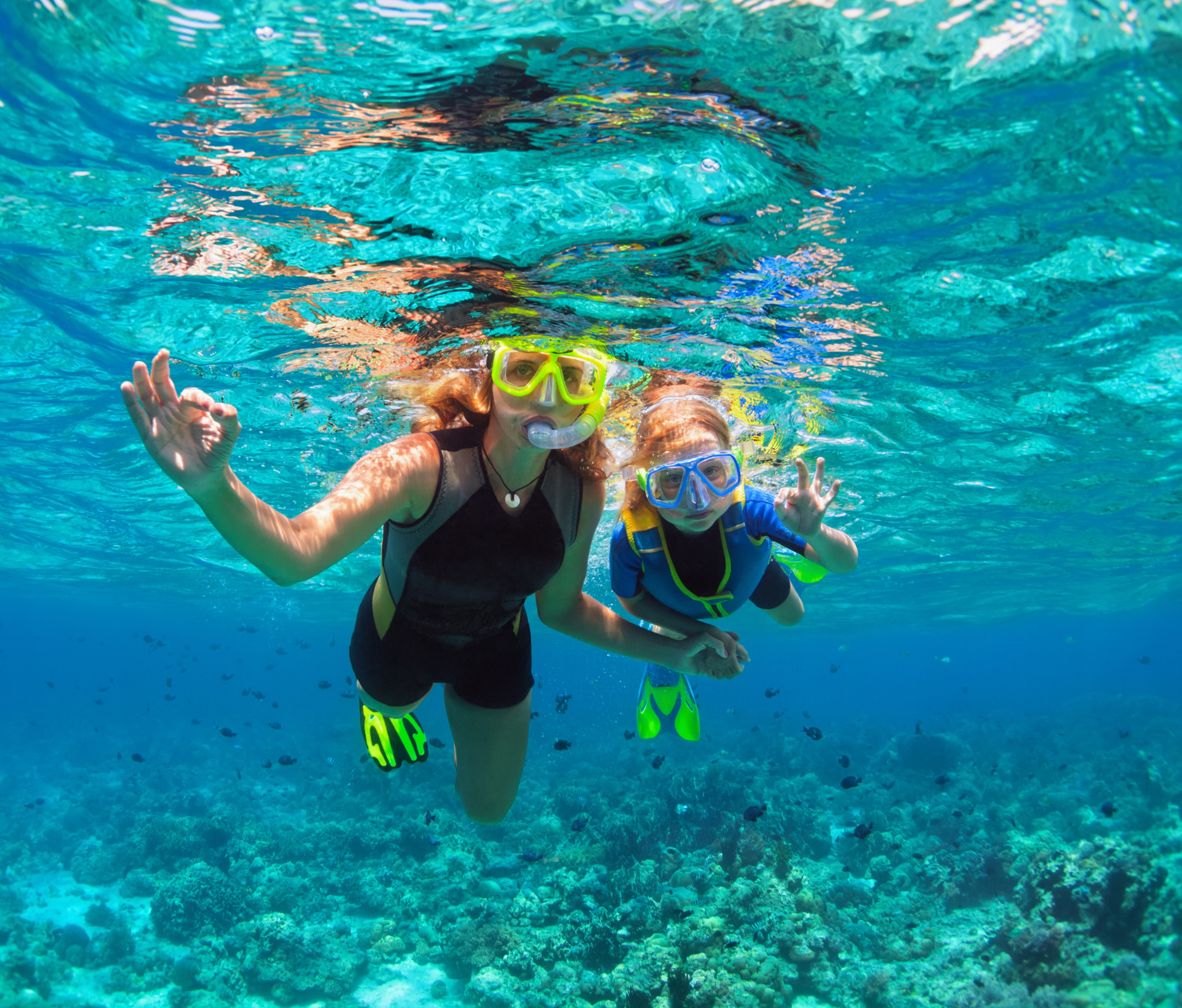 Two people snorkeling in the ocean at a Caribbean yacht charter destination.