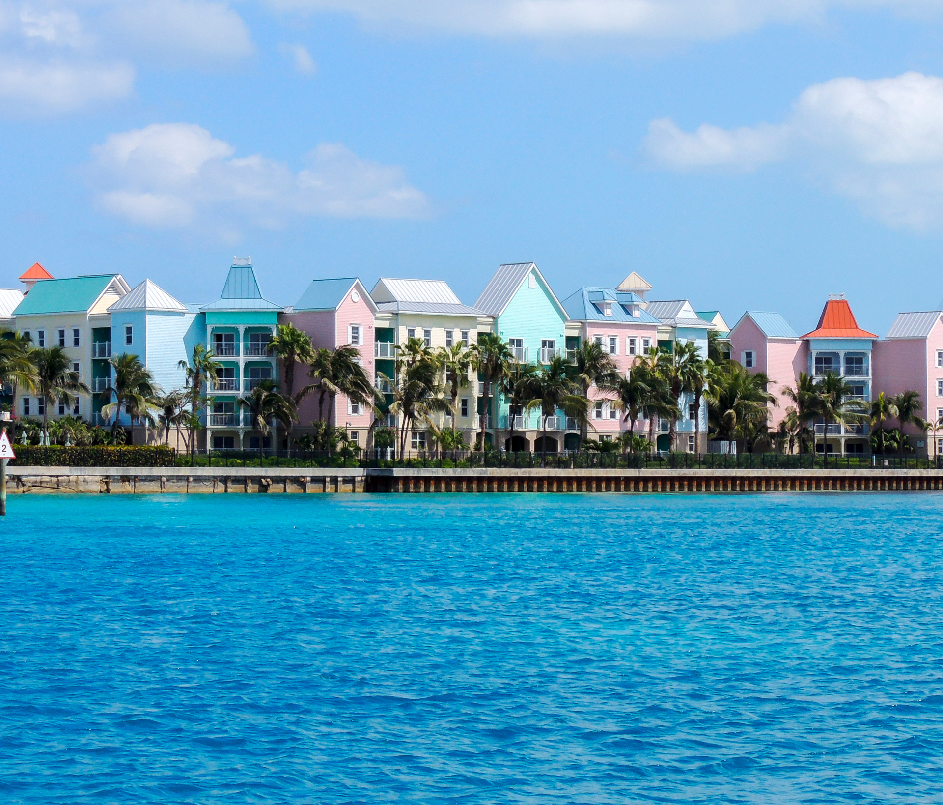 A Caribbean yacht charter destination with blue skies and white clouds.