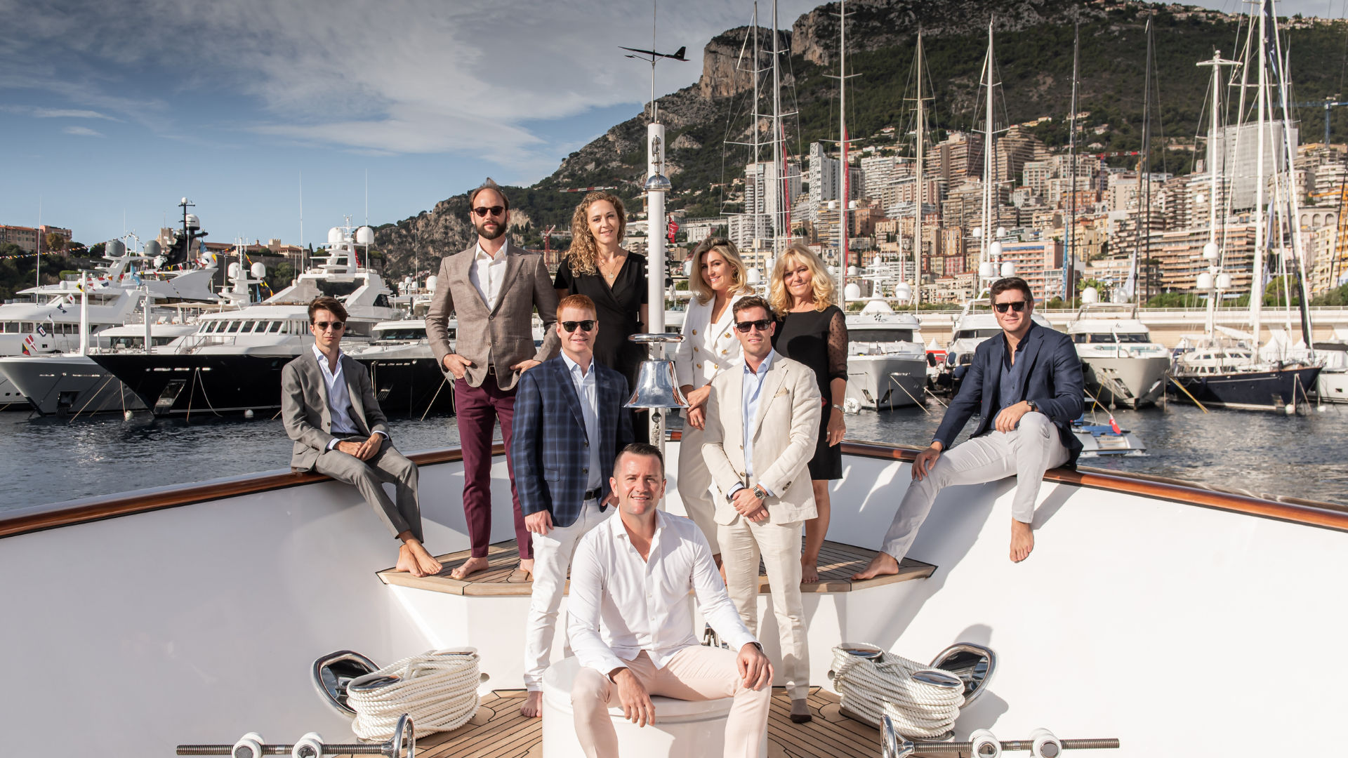 A group of people posing on the deck of a yacht in one of the top Caribbean yacht charter destinations.