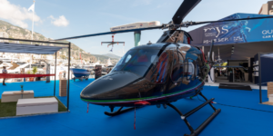 A helicopter parked on a blue floor, offering an exclusive experience.